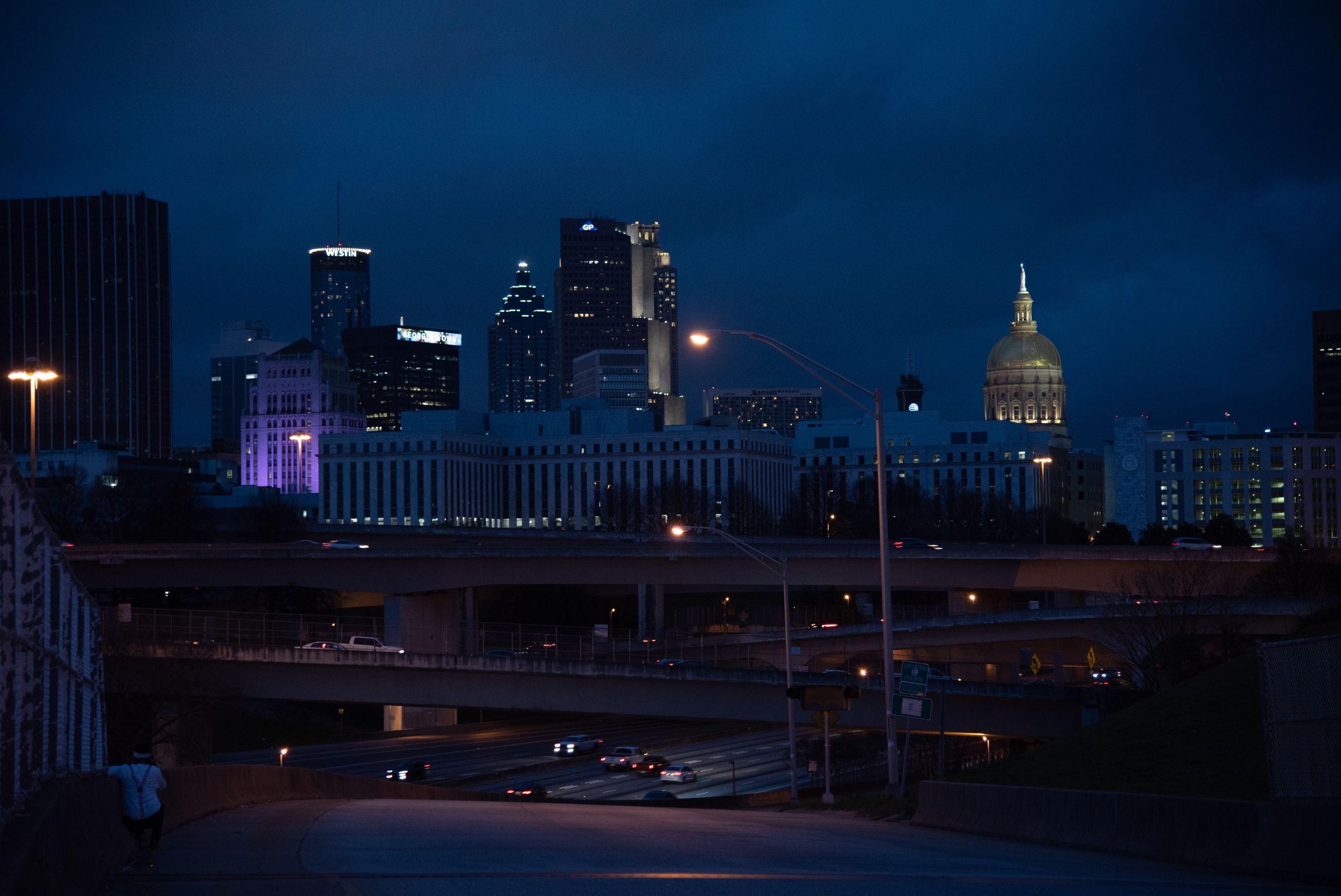 A captivating view of Atlanta's skyline with illuminated buildings and highways at night.