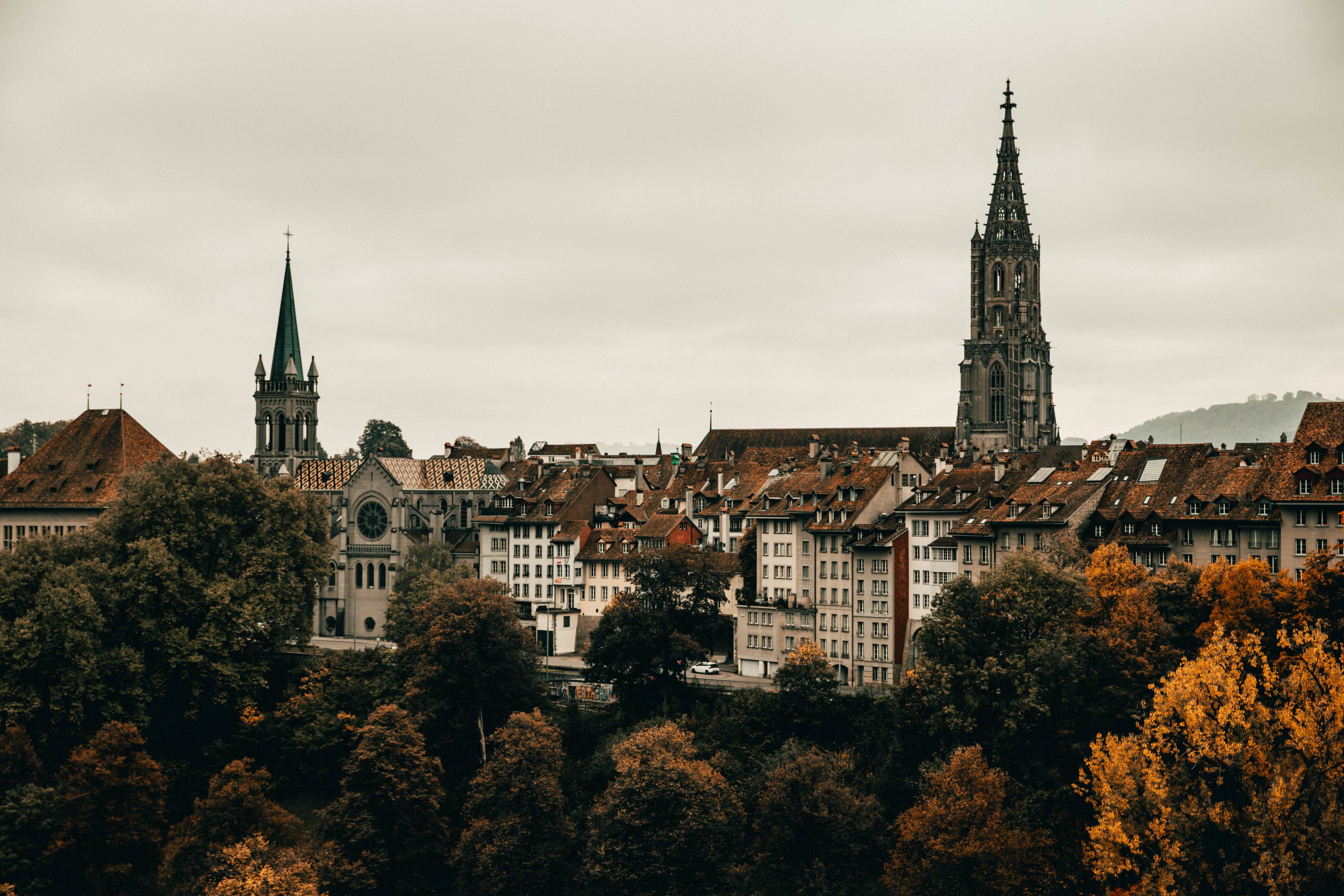 Explore the gothic architecture and vibrant autumn colors of Berne's cityscape from an elevated viewpoint.
