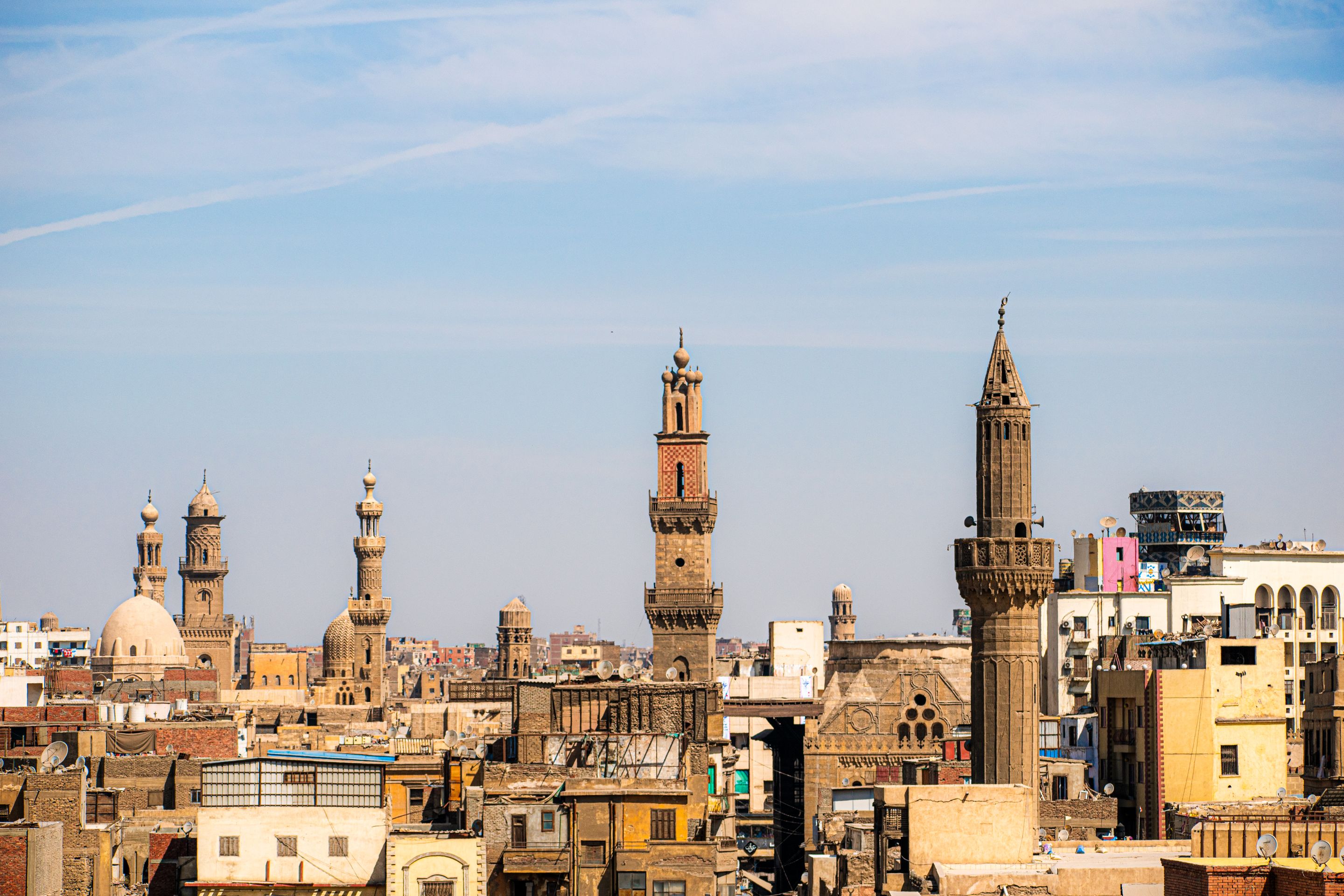 A captivating view of Cairo's skyline featuring historic mosques and minarets under a clear blue sky.
