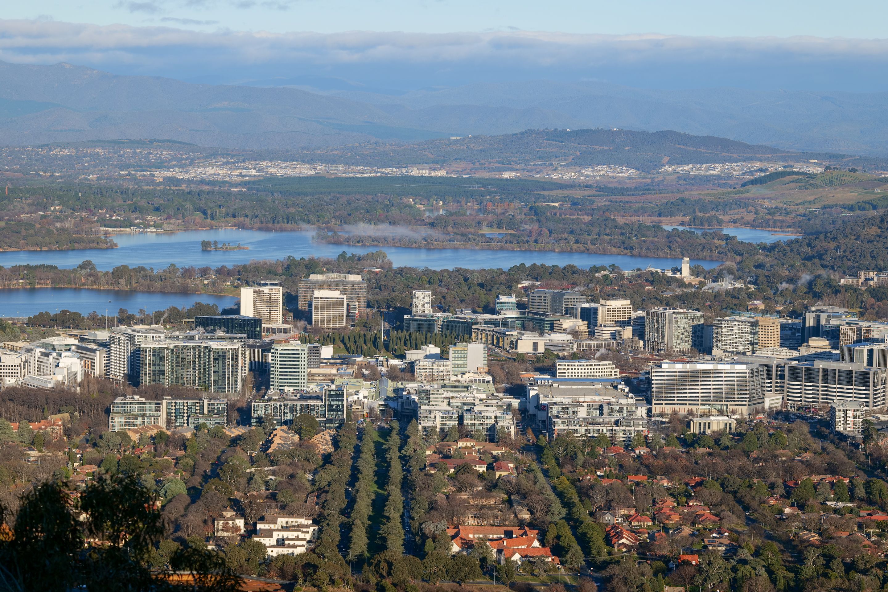 Scenic aerial cityscape of Canberra, Australia's capital, showcasing urban and natural elements.