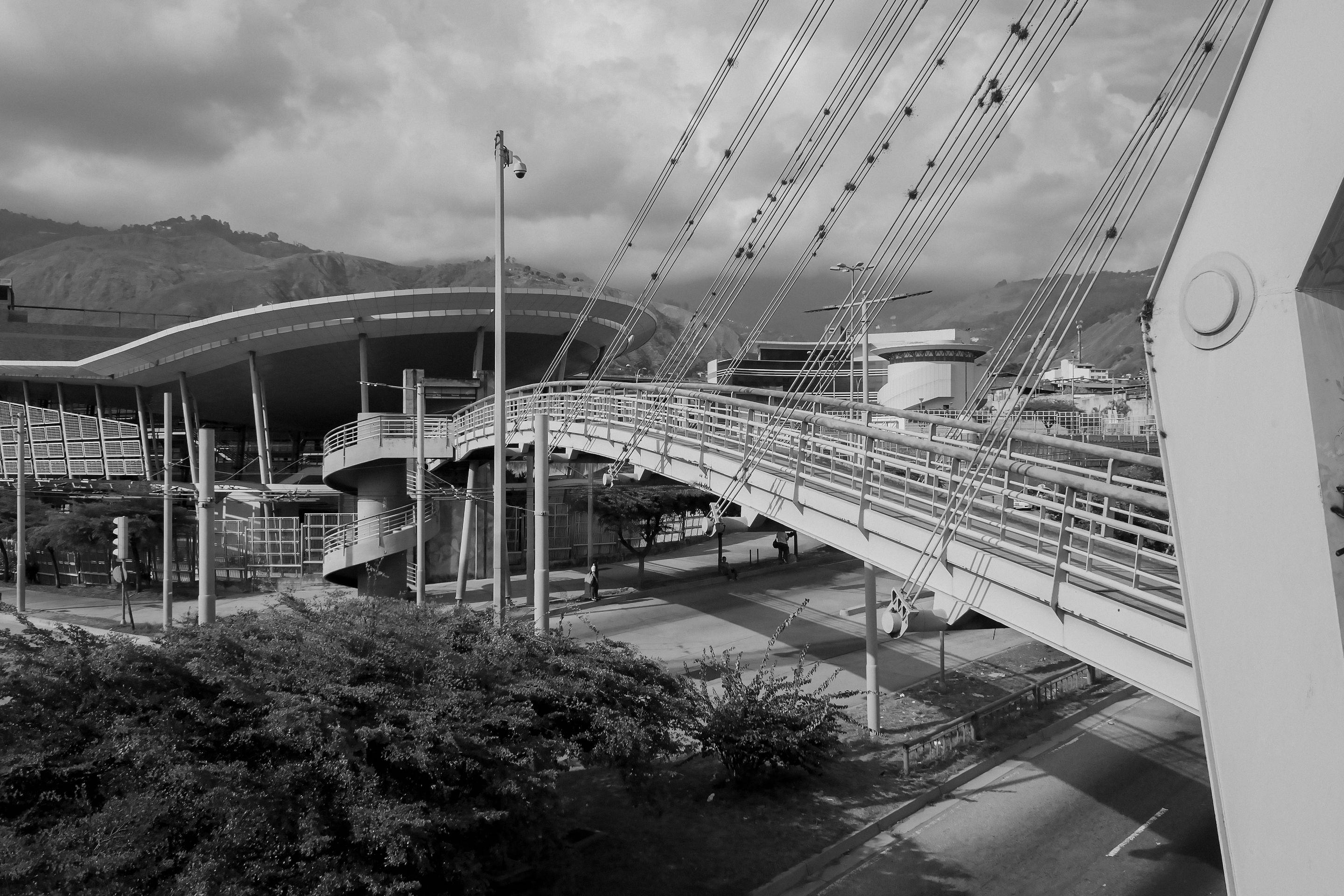 Explore the urban structure and design of a modern bridge in Mérida, Venezuela, in black and white.