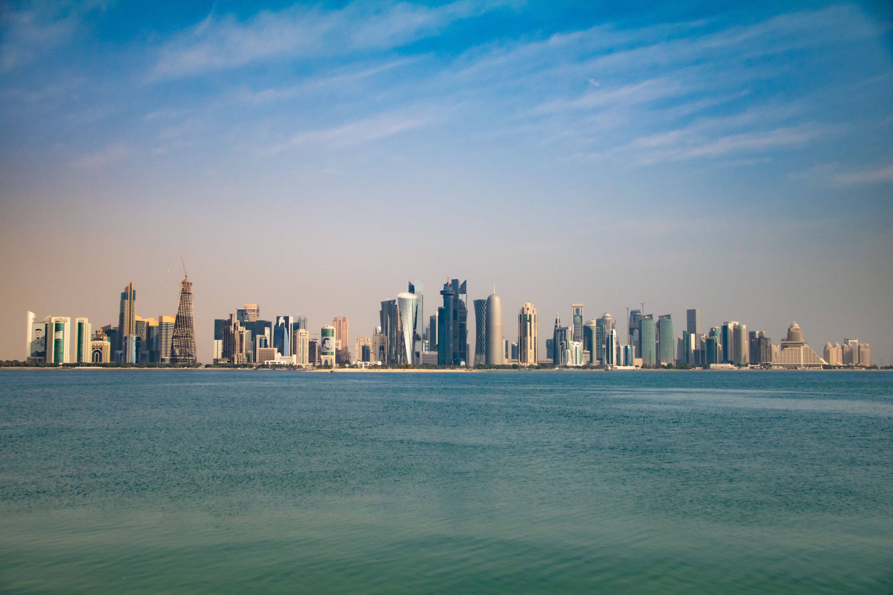 Captivating view of Doha skyline from the Corniche, featuring modern architecture under a clear blue sky.