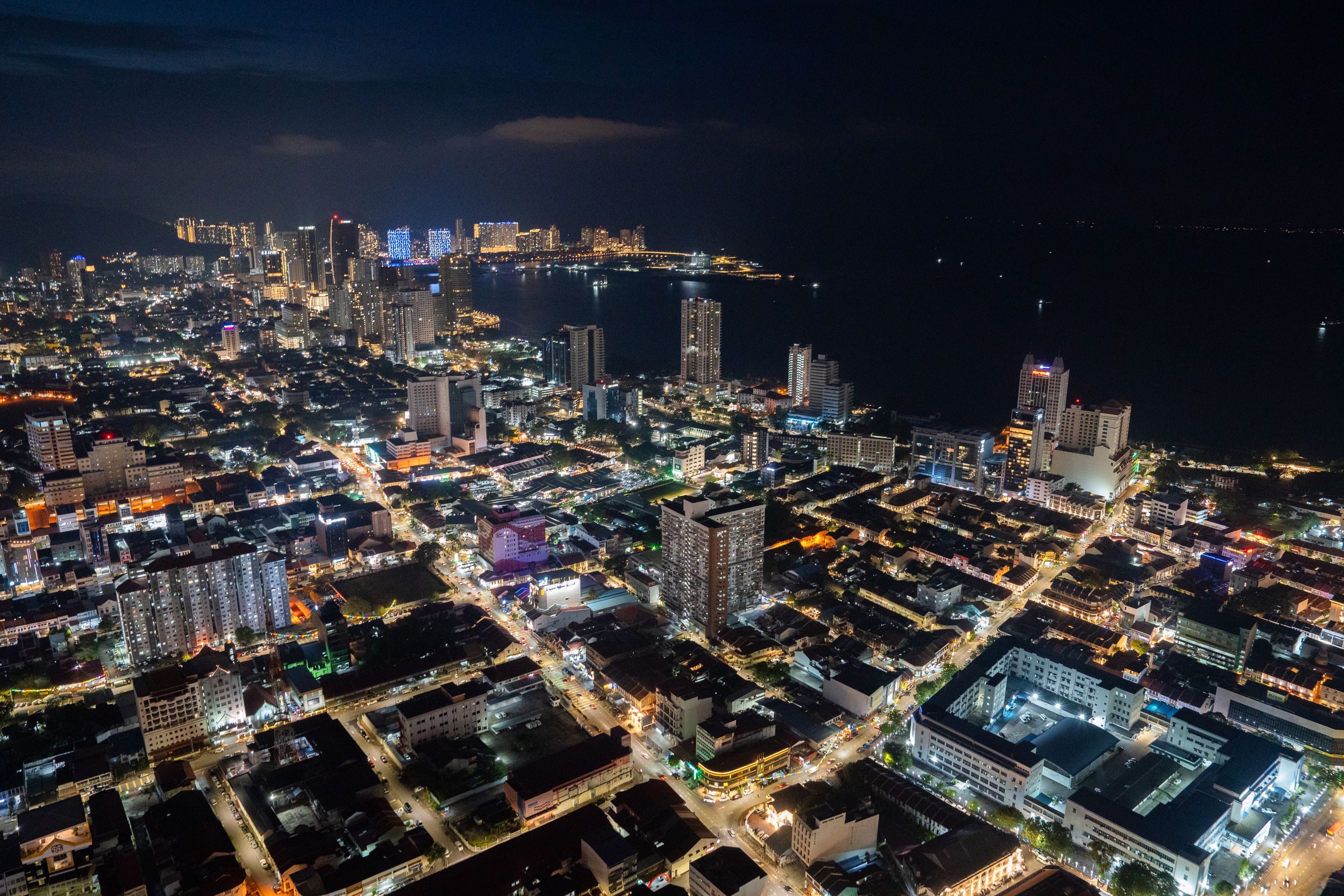 Aerial view showcasing the vibrant urban landscape and skyline of Penang, Malaysia at night.