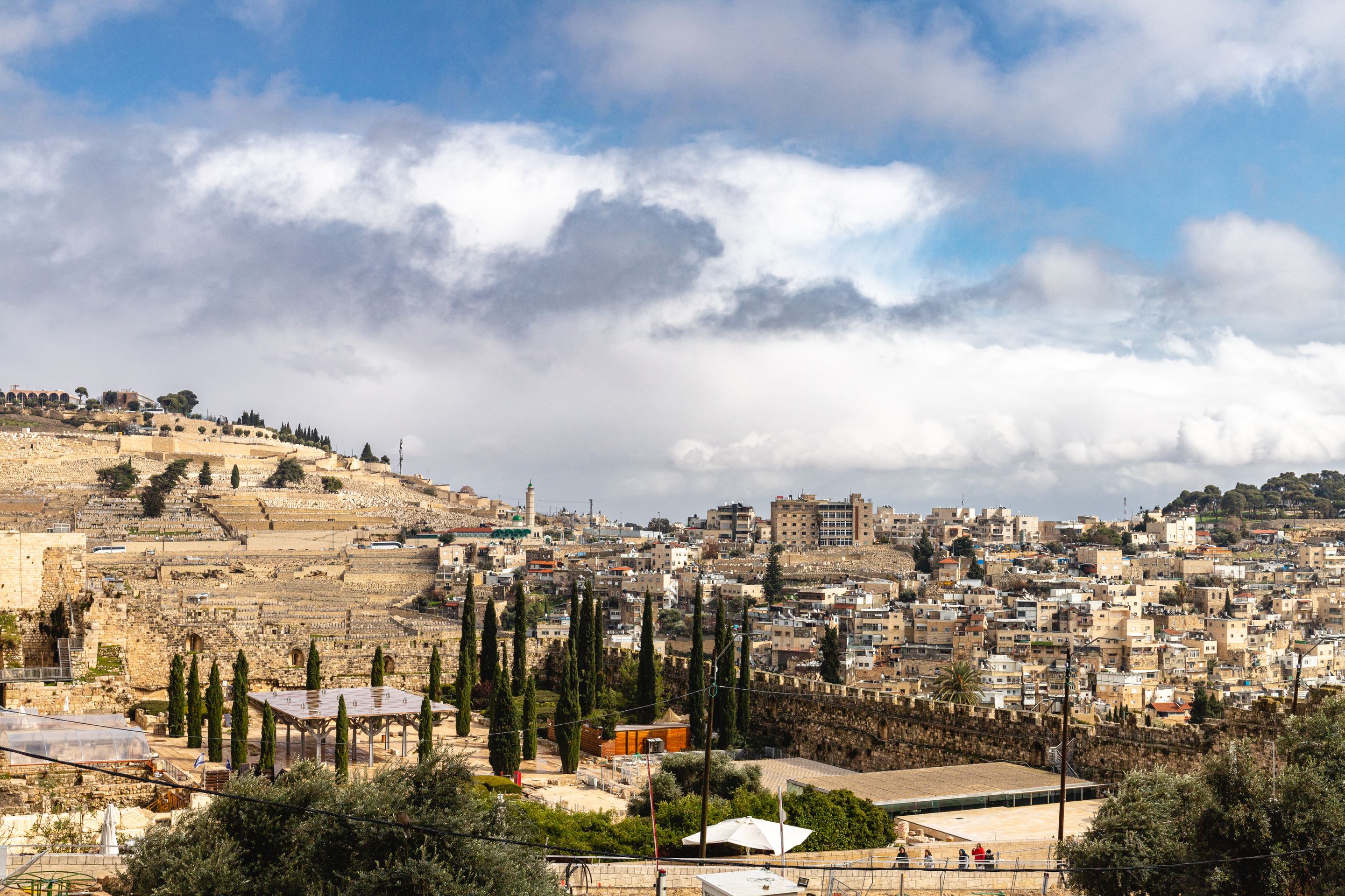 A panoramic view of Jerusalem's historic skyline under a vibrant sky.