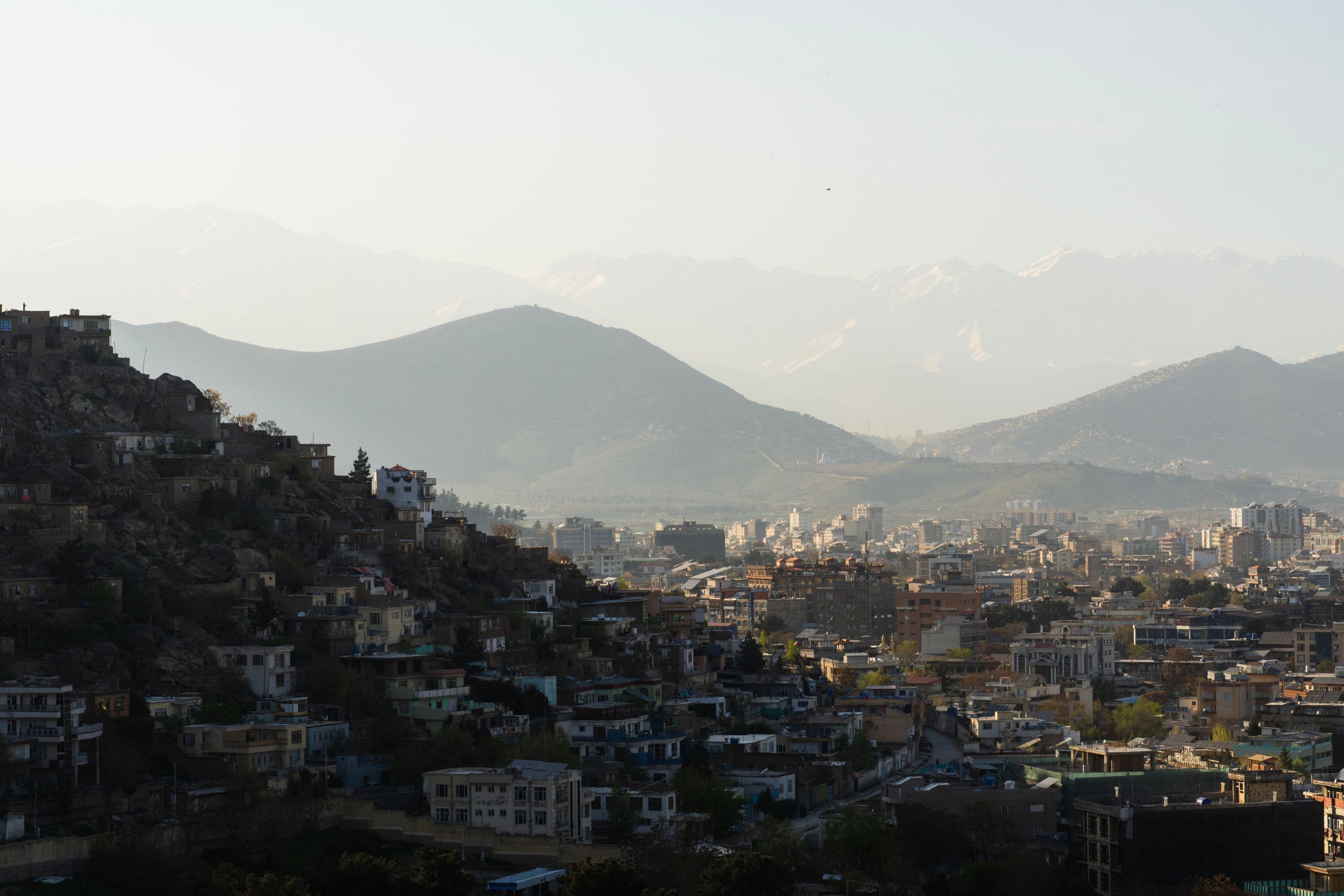 A stunning view of Kabul against a backdrop of mountains, capturing the city's architecture under a clear sky.