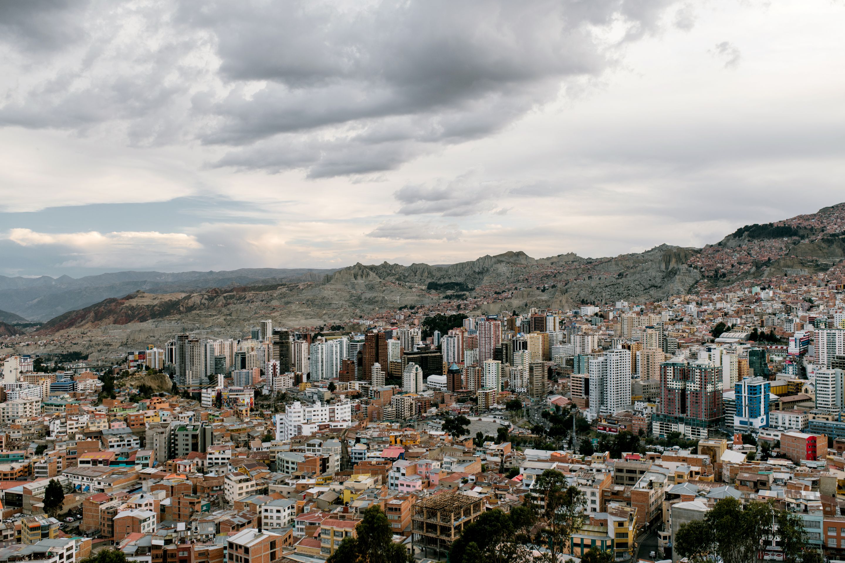 Panoramic view of La Paz, Bolivia with city buildings and dramatic skies.