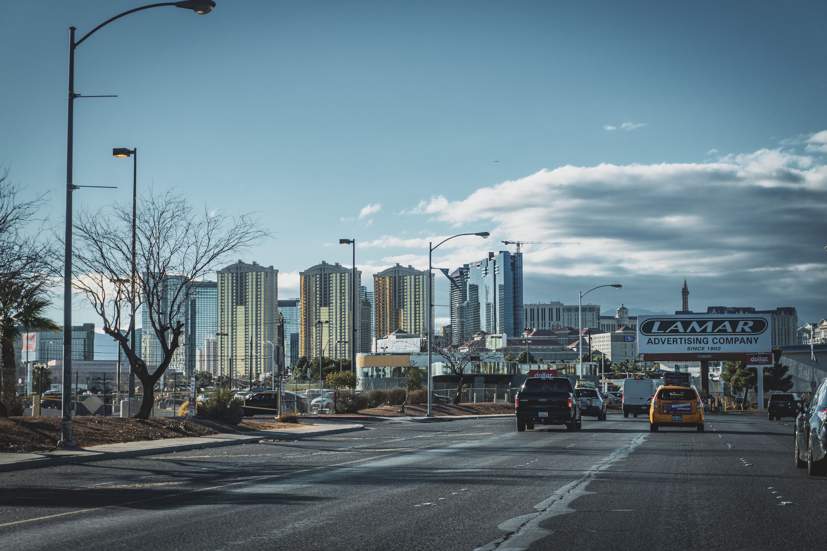Dynamic view of Las Vegas skyline with bustling street traffic and modern skyscrapers.
