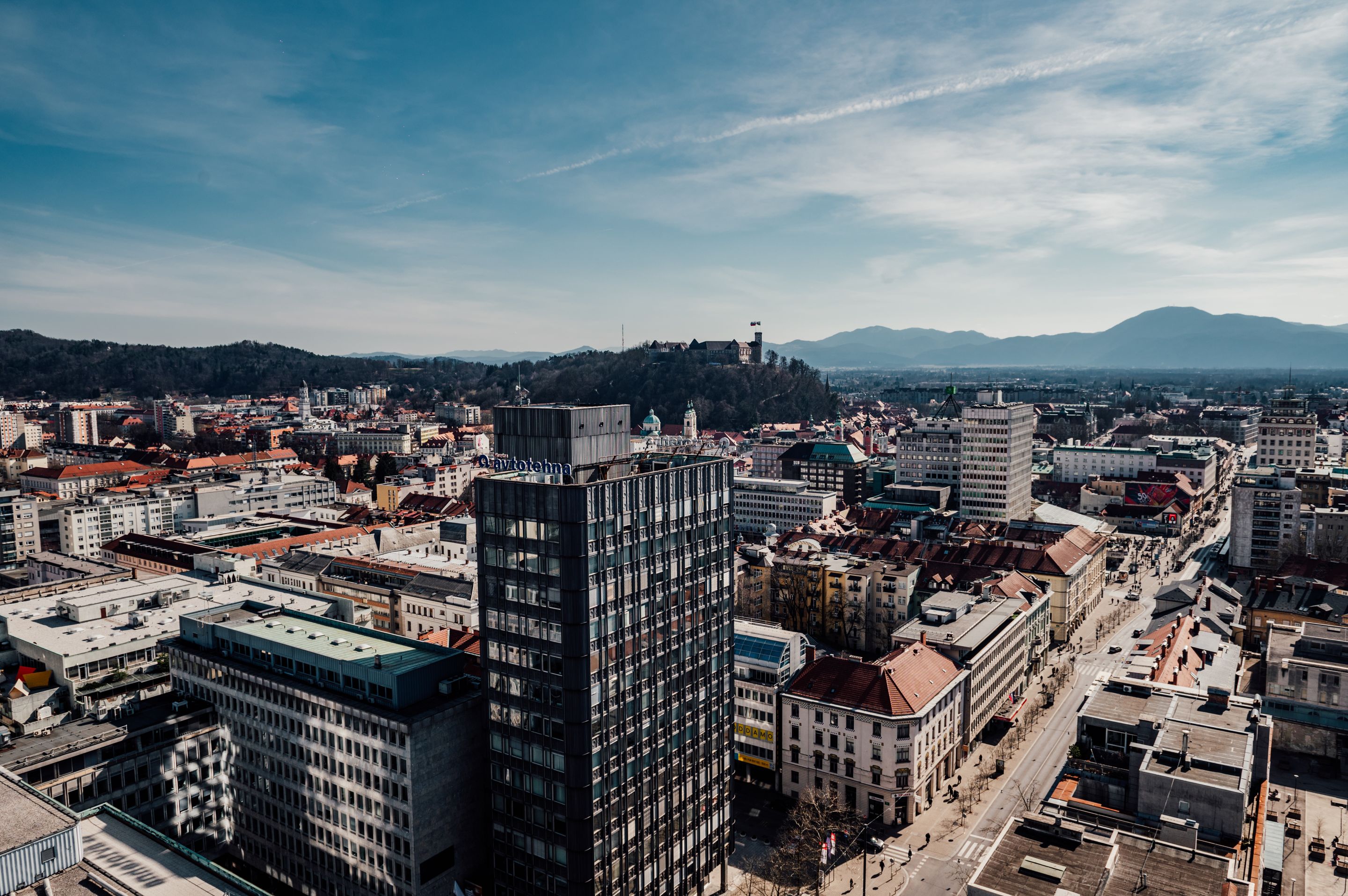 A breathtaking aerial shot showcasing Ljubljana's vibrant cityscape under a clear blue sky.