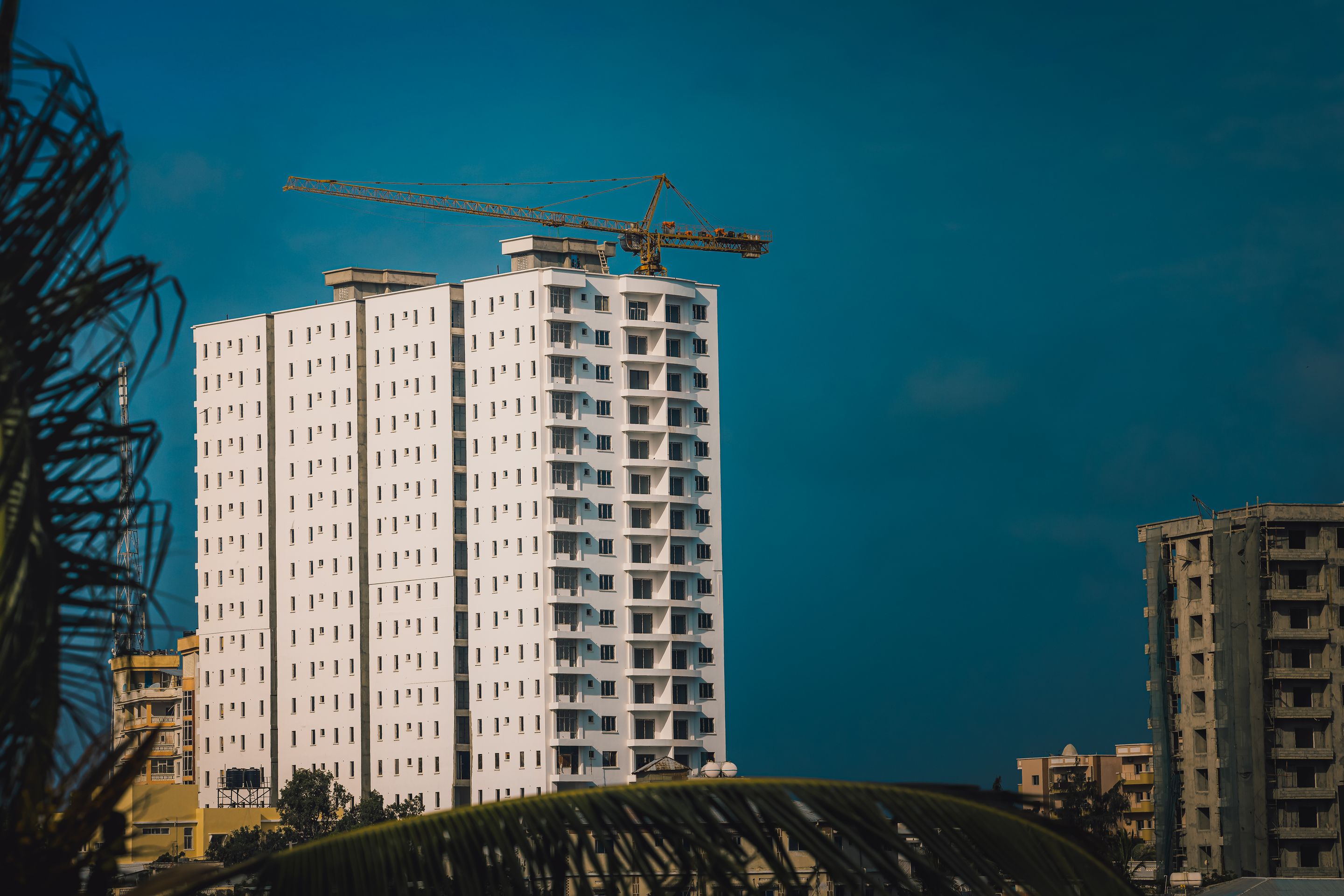 High-rise building under construction with tower crane in Mogadishu, Somalia.