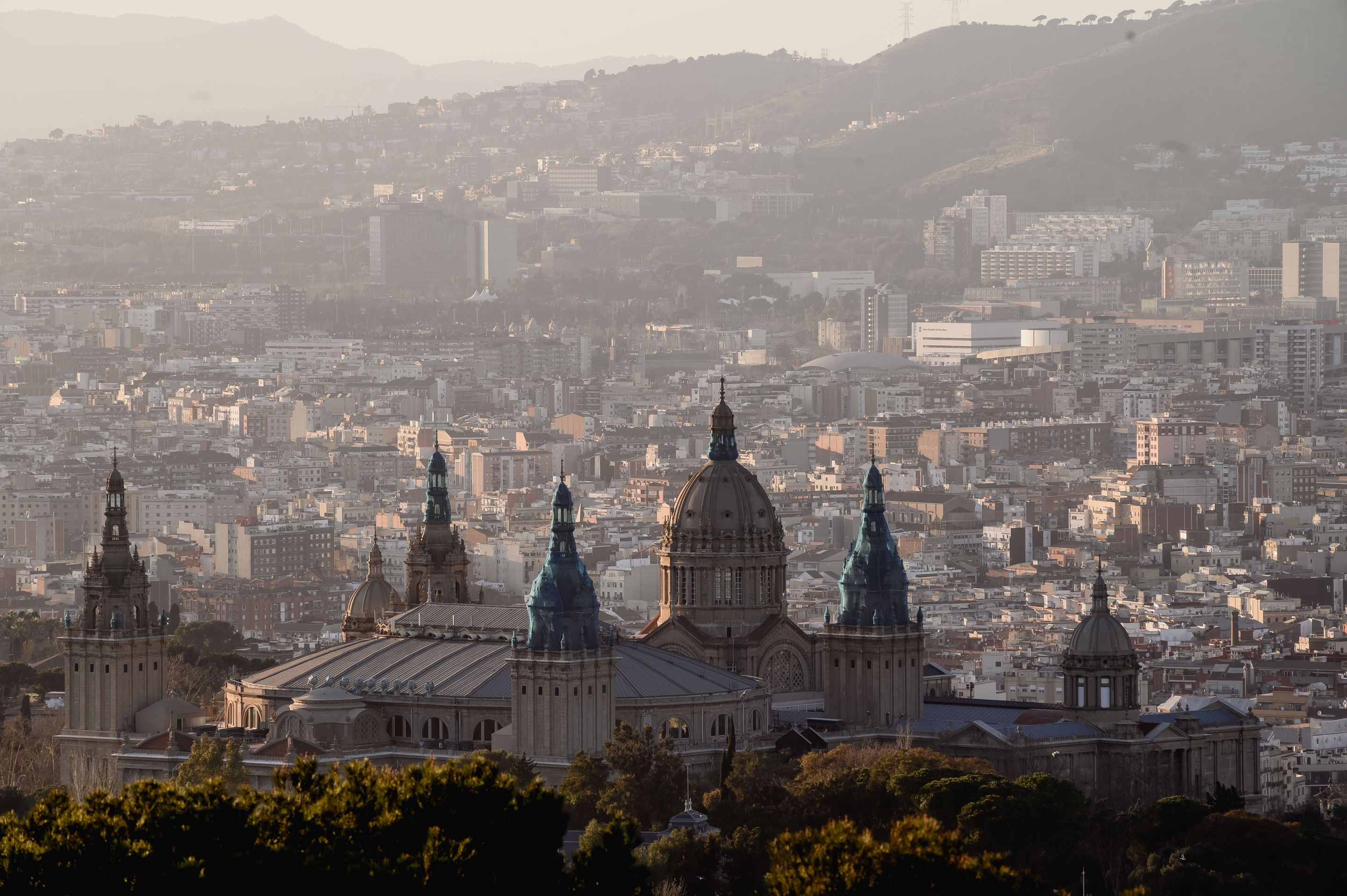Scenic view of Barcelona with the National Art Museum foreground and cityscape background.
