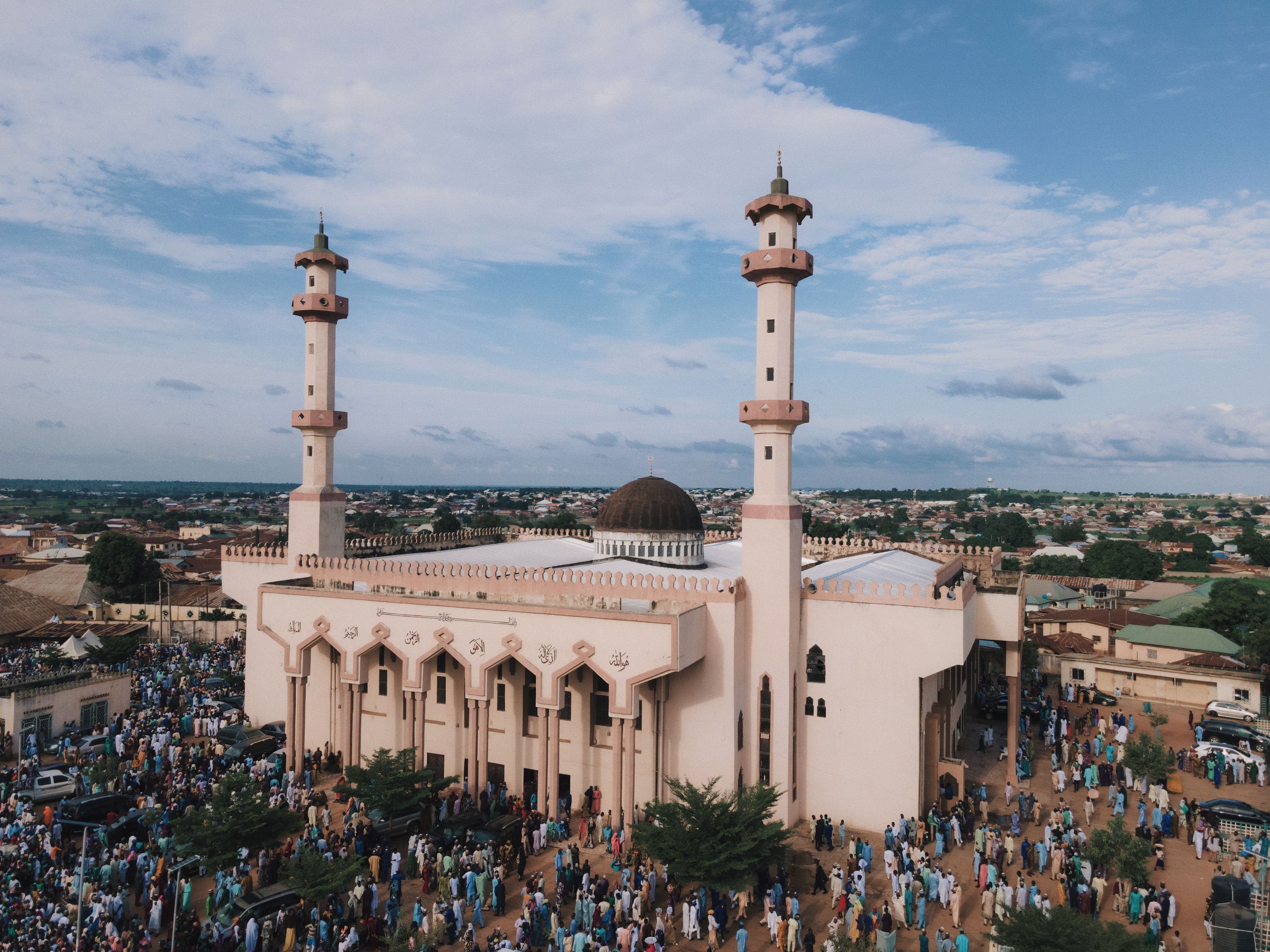 Stunning aerial photograph of a bustling mosque in Nigeria, capturing vibrant community life.