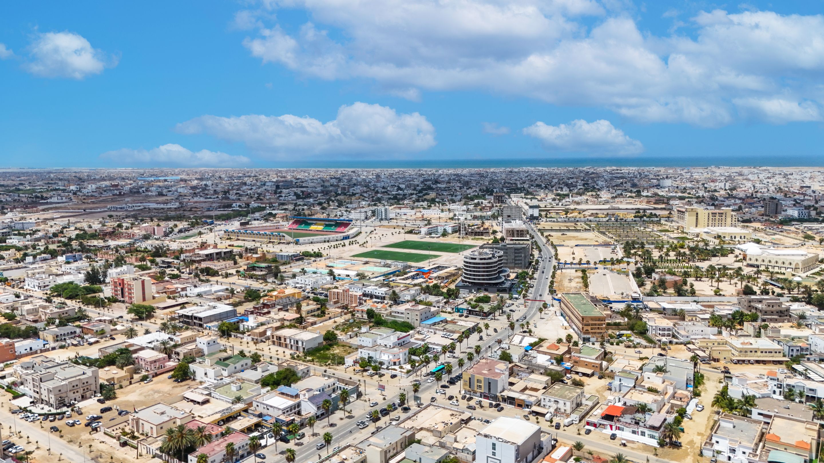 Stunning aerial shot of Nouakchott, Mauritania, showcasing urban sprawl under a bright blue sky.