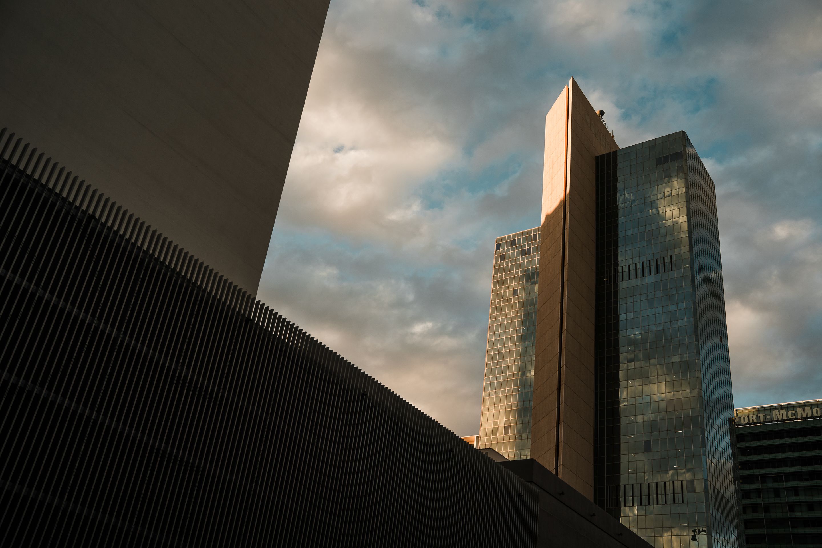 Tall skyscrapers in downtown Phoenix reflecting the sunset sky, showcasing modern architecture.