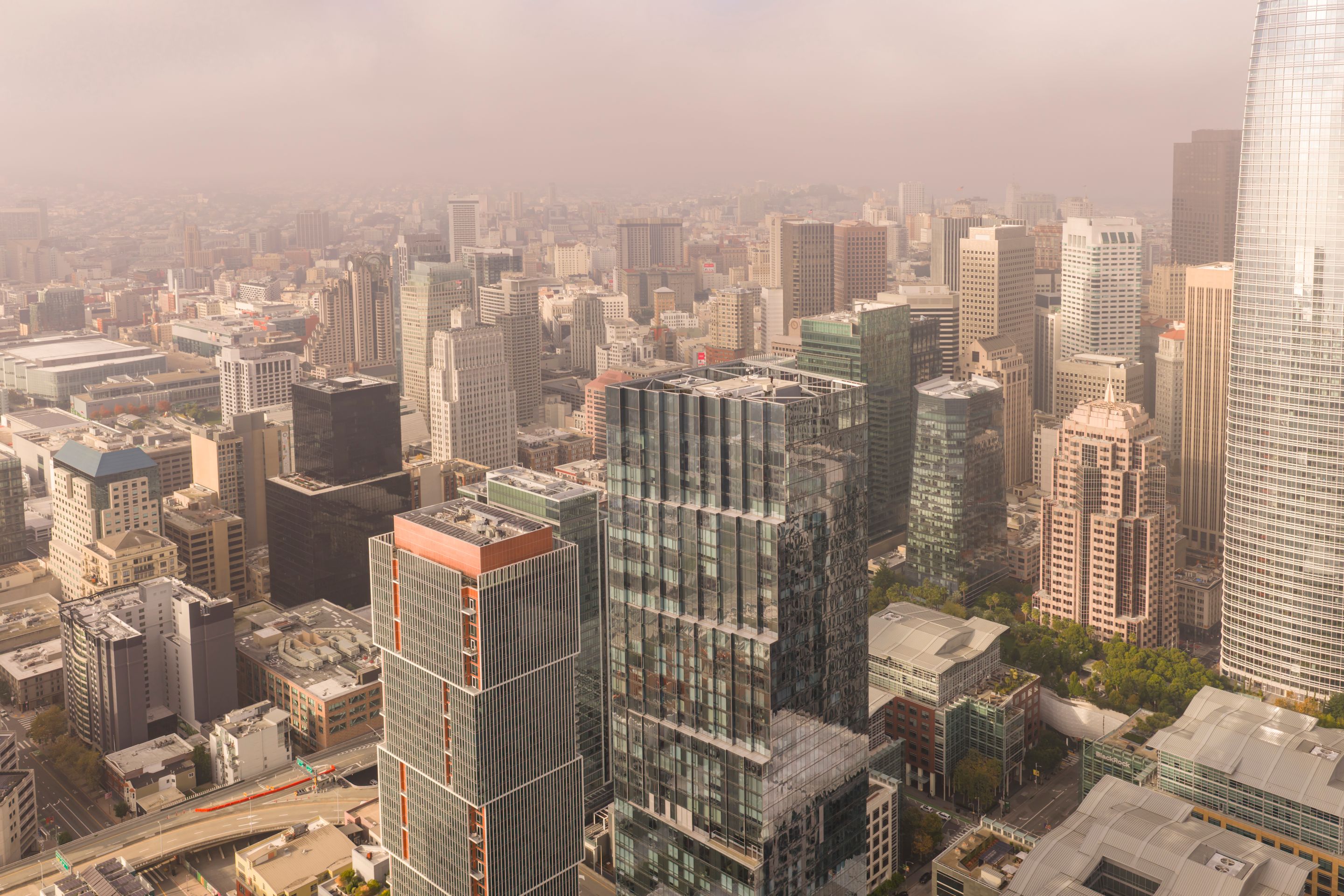 Stunning aerial view of San Francisco's modern skyline showcasing prominent skyscrapers on a foggy day.