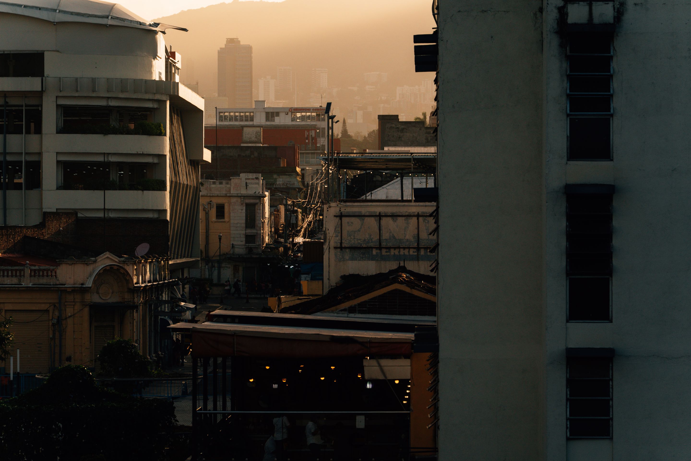 A stunning view of San Salvador's cityscape at sunset, capturing historic and modern architecture.