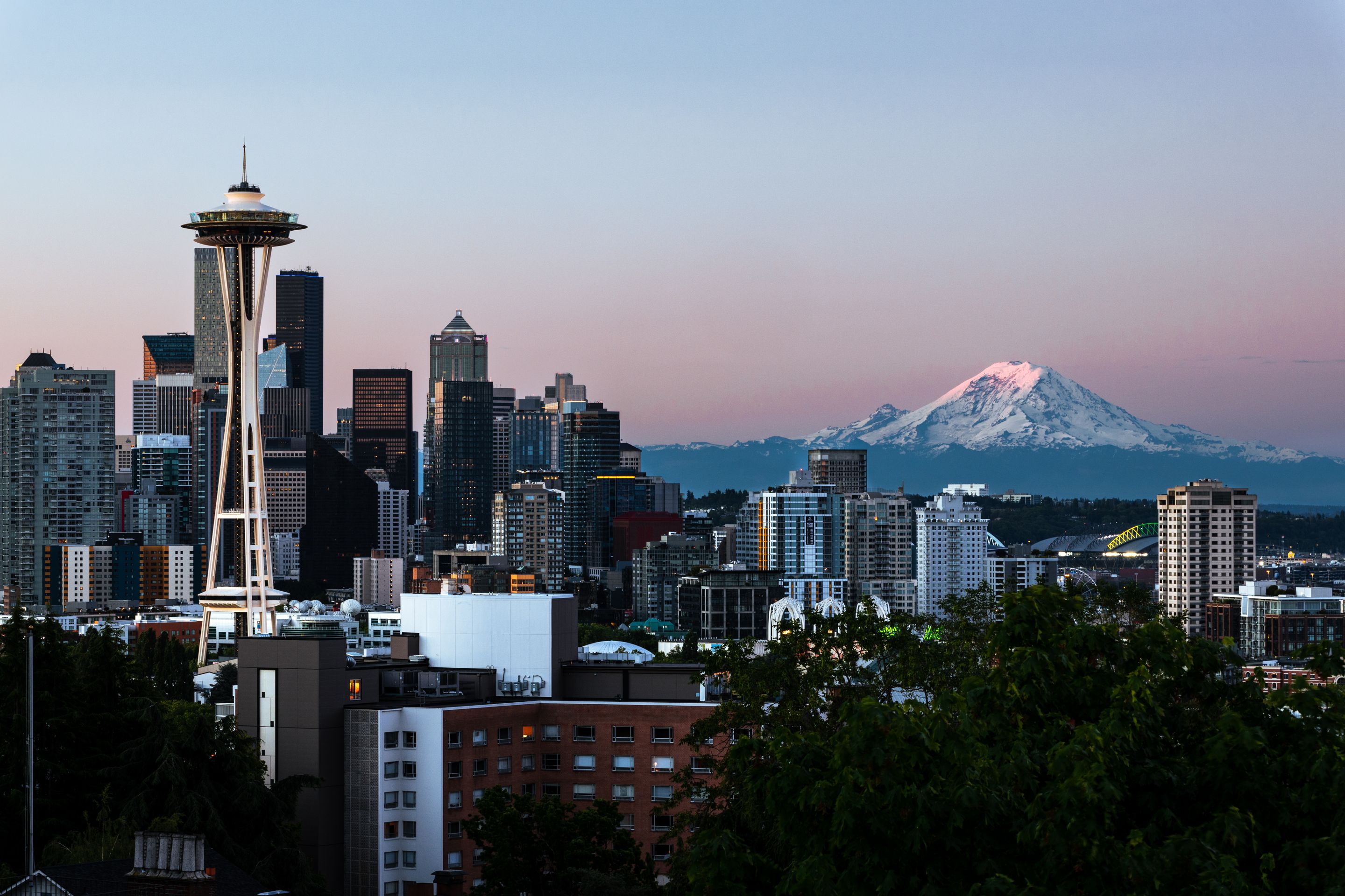 Captivating view of Seattle's skyline featuring the Space Needle and Mount Rainier at dawn.